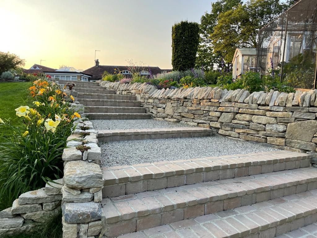Stone steps with drystone retaining wall at sunset