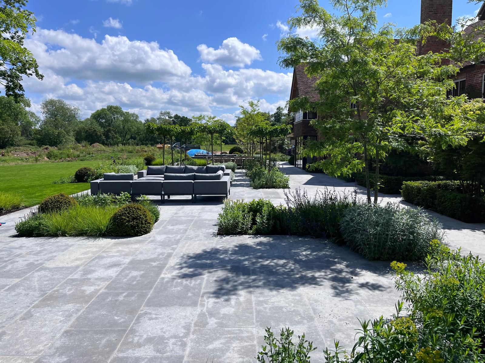 Estate garden with formal bluestone paving by Carters Landscaping and Construction