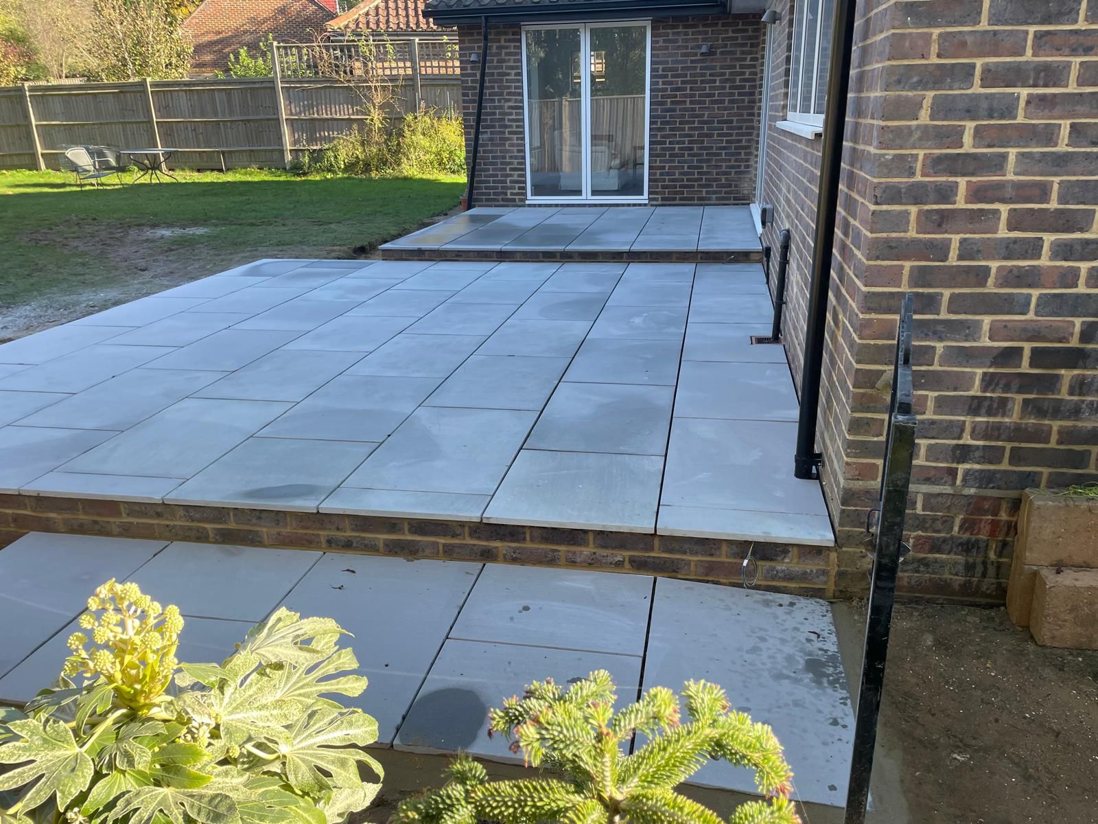 Grey porcelain patio with raised steps