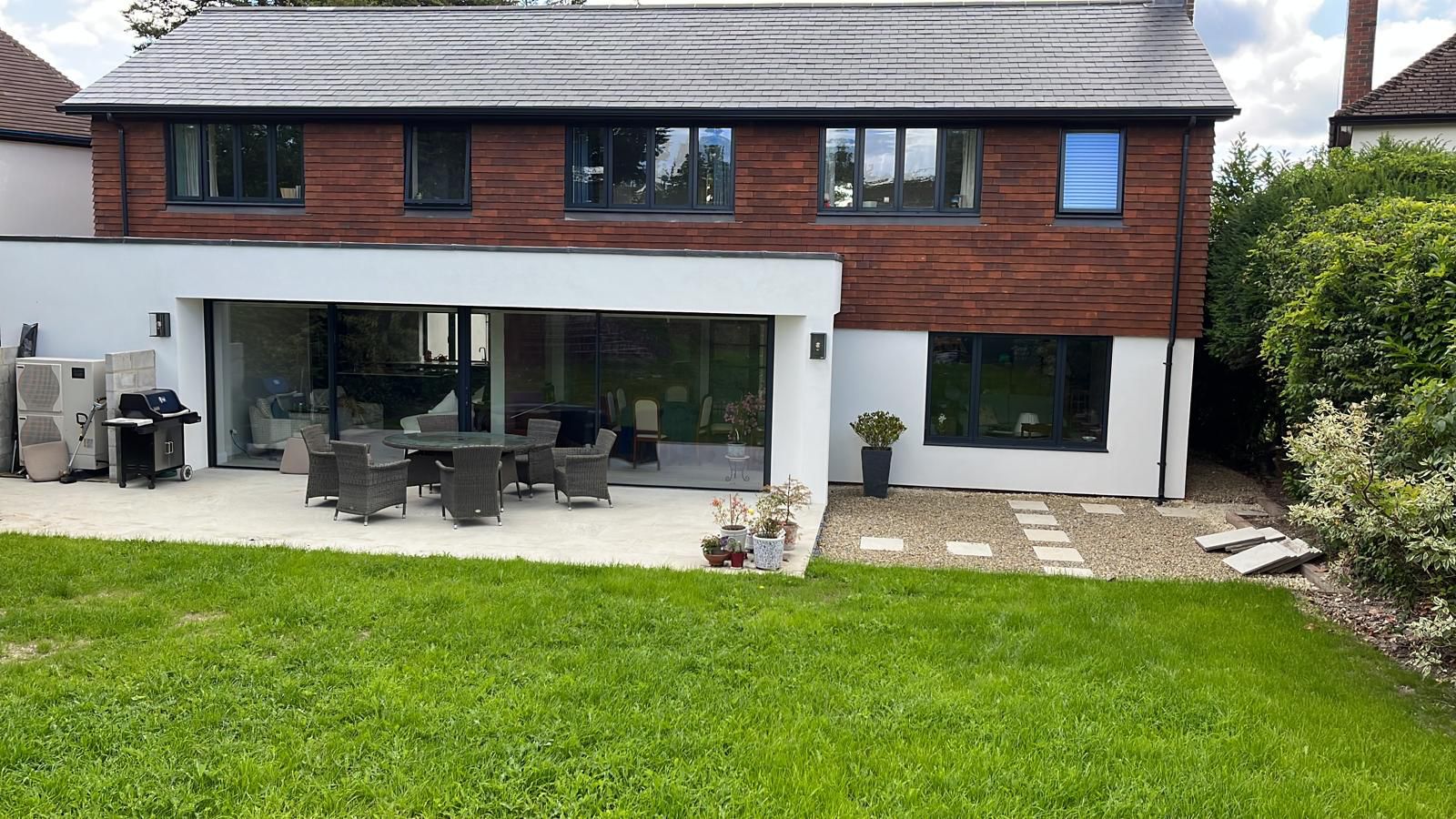 Natural stone patio overlooking house and lawn