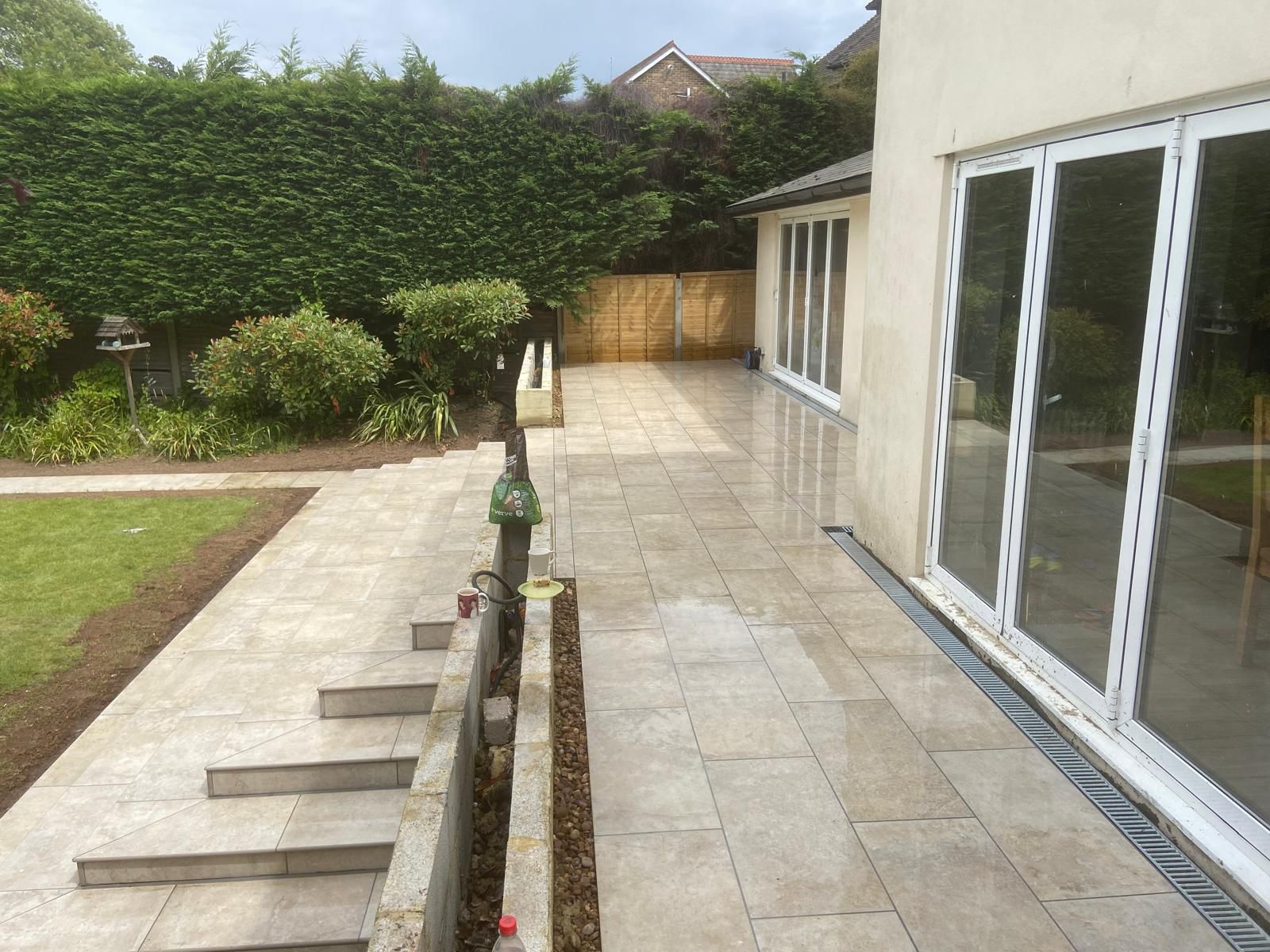 Porcelain patio with garden steps and drainage