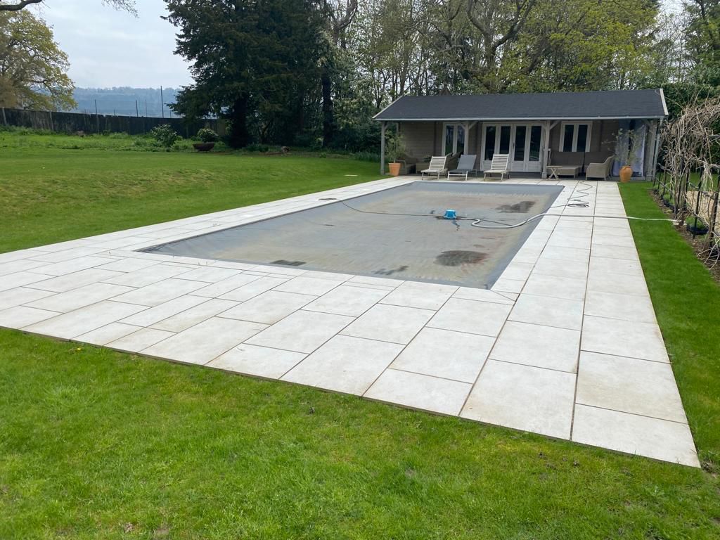 White stone surround with covered pool